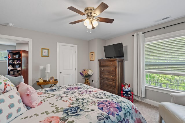 bedroom with visible vents, carpet flooring, baseboards, and a ceiling fan