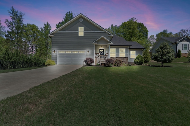 traditional home featuring an attached garage, a front yard, and concrete driveway