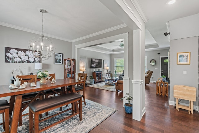 dining space featuring crown molding, ceiling fan with notable chandelier, a raised ceiling, and dark wood-style flooring