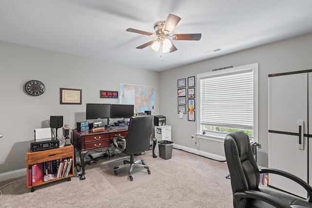 office space featuring visible vents, baseboards, carpet, and ceiling fan
