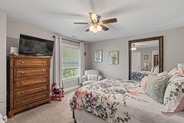 carpeted bedroom with visible vents, baseboards, and ceiling fan
