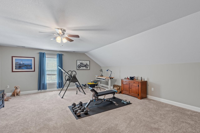 exercise area with lofted ceiling, baseboards, a ceiling fan, and carpet flooring