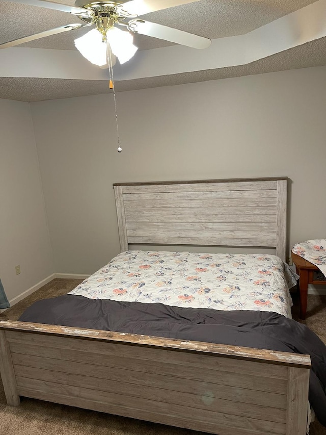 unfurnished bedroom with ceiling fan, carpet flooring, and a textured ceiling