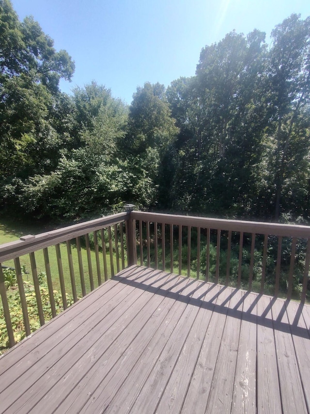 wooden terrace featuring a yard