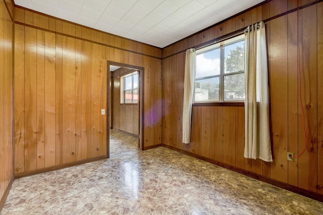 unfurnished room featuring wood walls