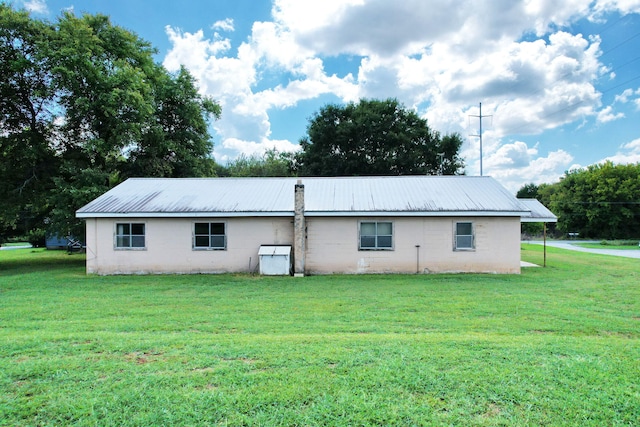 back of property with a yard