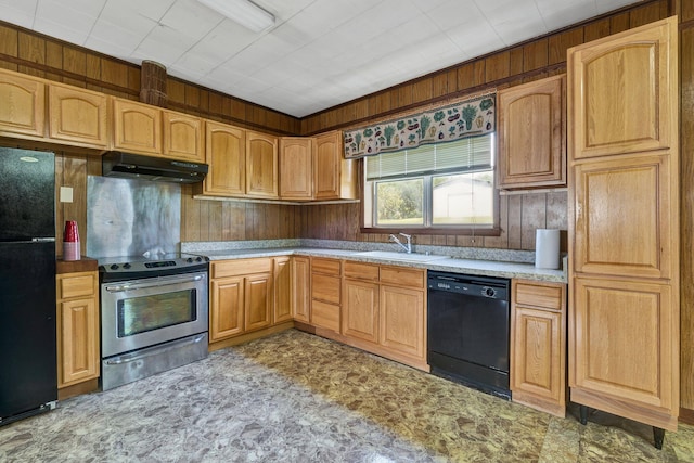 kitchen with sink, wood walls, and black appliances