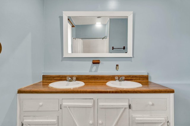 bathroom with vanity and curtained shower