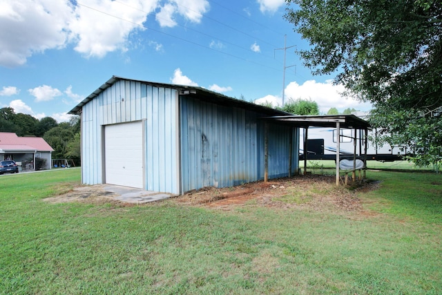 view of outbuilding with a yard and a garage