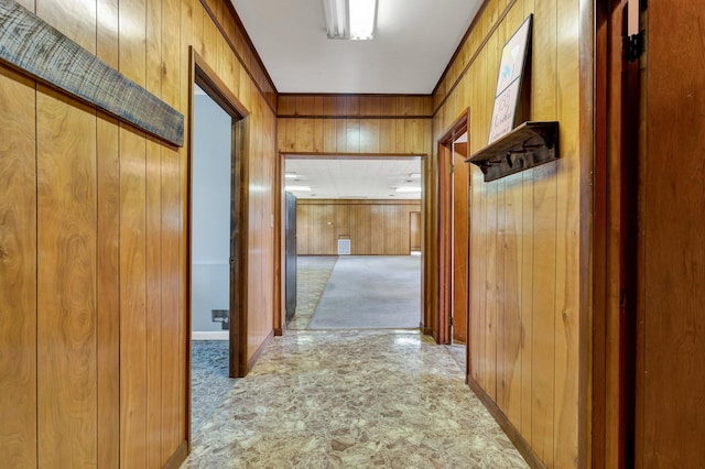 hall with light carpet and wooden walls