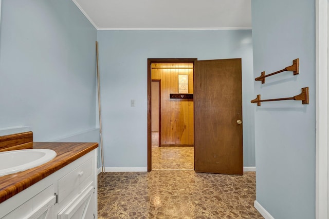 bathroom with vanity and ornamental molding