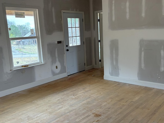 doorway to outside with light hardwood / wood-style flooring and a healthy amount of sunlight