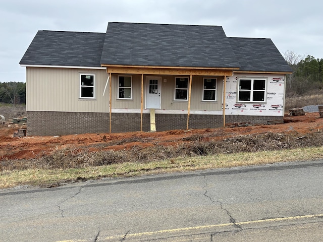 view of side of property with a porch