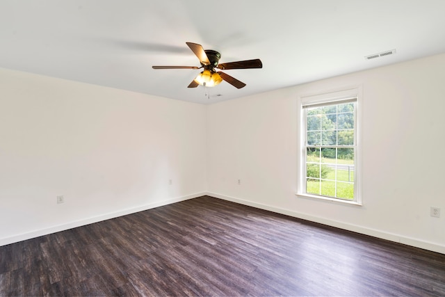 empty room featuring ceiling fan and dark hardwood / wood-style floors