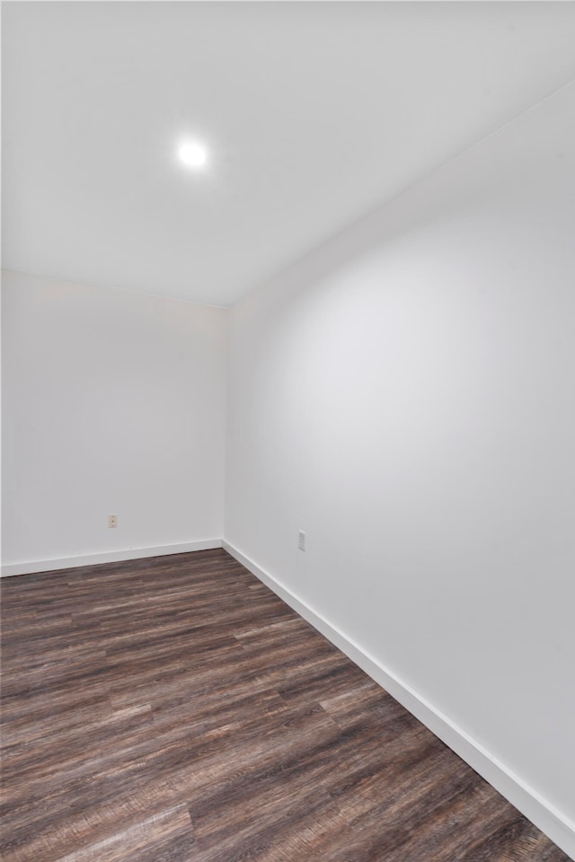 spare room with dark hardwood / wood-style flooring