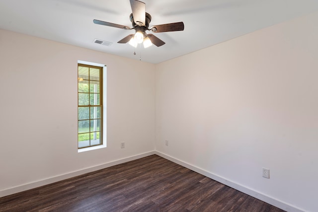 empty room with ceiling fan and dark hardwood / wood-style flooring