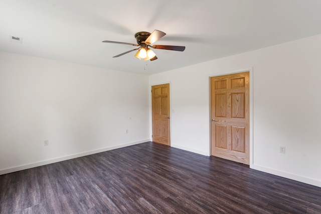 spare room featuring dark hardwood / wood-style floors and ceiling fan