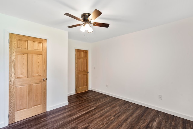 unfurnished bedroom with ceiling fan and dark wood-type flooring