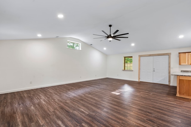 unfurnished living room featuring ceiling fan, dark wood-type flooring, and vaulted ceiling