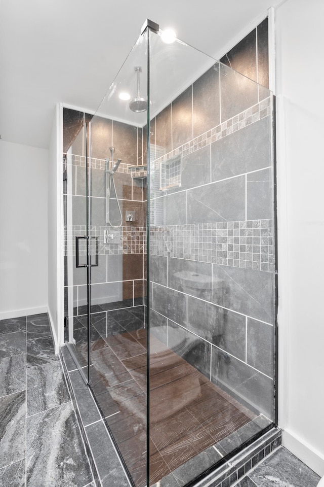 bathroom with a shower with shower door