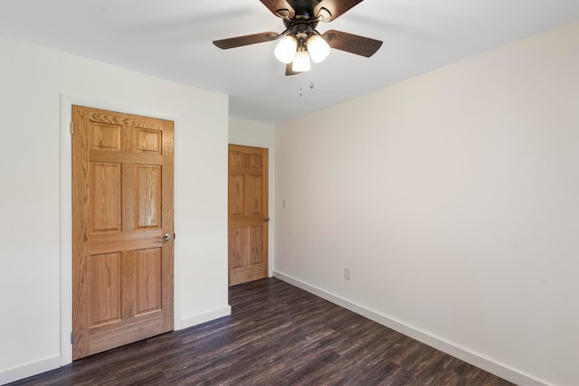 unfurnished bedroom with ceiling fan and dark hardwood / wood-style flooring