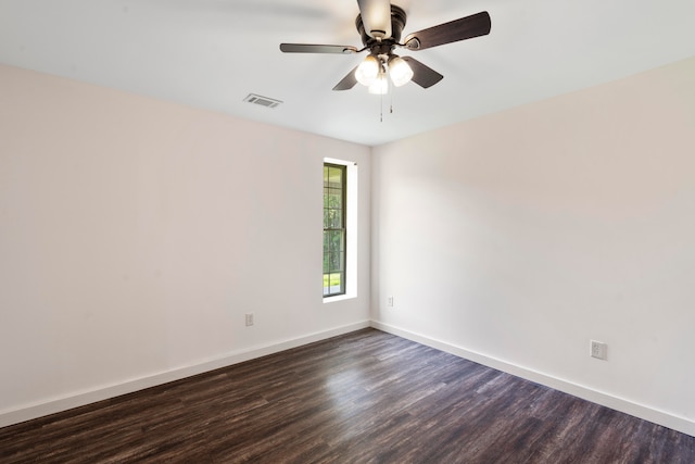 empty room with dark hardwood / wood-style flooring and ceiling fan