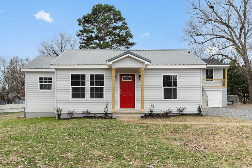 view of front of house with a front yard and a garage