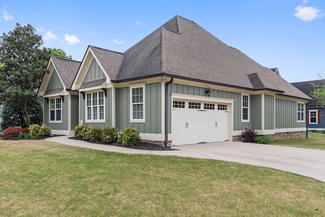view of front facade with concrete driveway, board and batten siding, a shingled roof, an attached garage, and a front yard