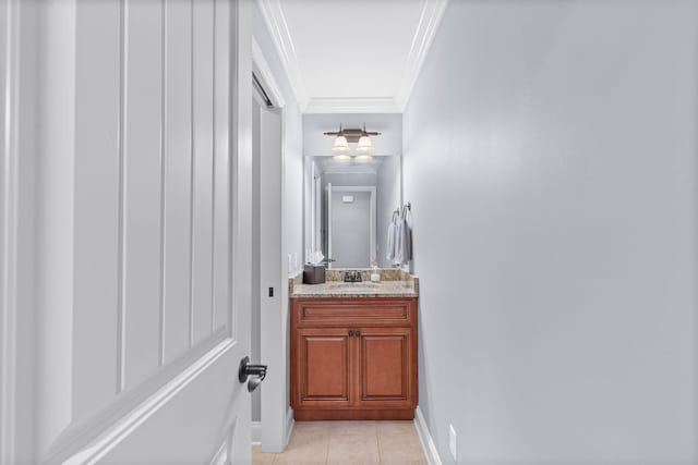 bathroom featuring vanity, tile patterned flooring, baseboards, and ornamental molding