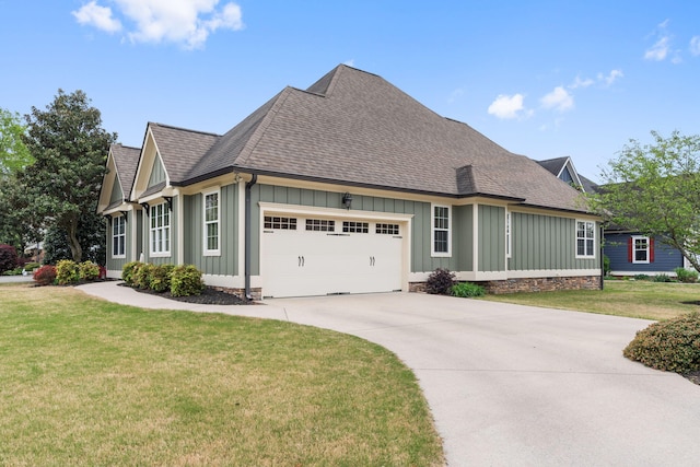 view of front of house with a front lawn, driveway, board and batten siding, a shingled roof, and an attached garage