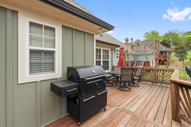 deck with grilling area and outdoor dining area
