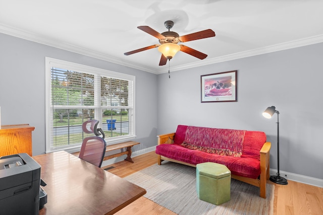 office space featuring a ceiling fan, baseboards, crown molding, and wood finished floors
