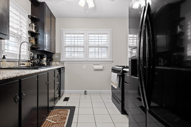 kitchen with black appliances, a sink, open shelves, light tile patterned floors, and ceiling fan