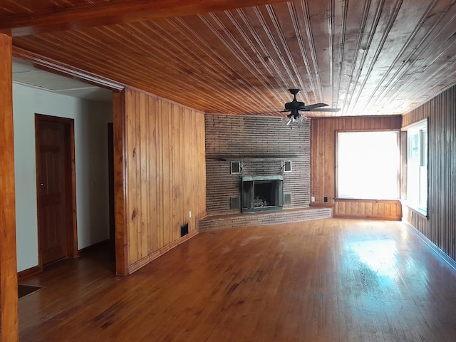 364 Cherokee Trl, Copperhill, TN 37317 - unfurnished living room featuring wooden ceiling, a ceiling fan, a fireplace, wood walls, and hardwood / wood-style floors