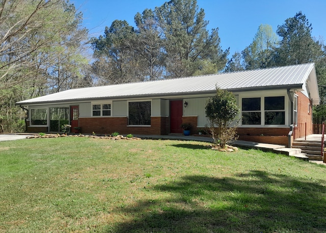 364 Cherokee Trl, Copperhill, TN 37317 - ranch-style house with brick siding, metal roof, and a front lawn
