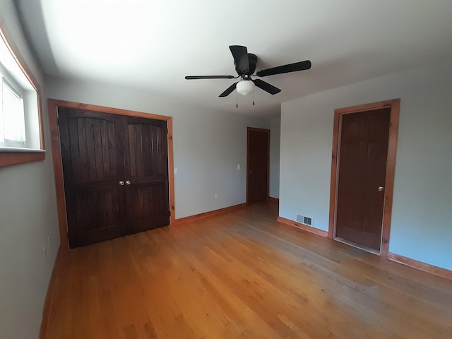 364 Cherokee Trl, Copperhill, TN 37317 - unfurnished bedroom with light wood-style flooring, baseboards, a ceiling fan, and visible vents