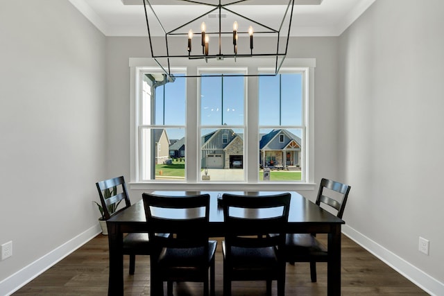 dining room featuring ornamental molding, dark wood-type flooring, and a wealth of natural light