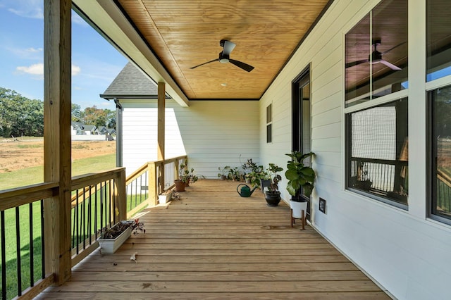 wooden terrace featuring ceiling fan