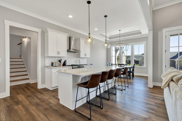 kitchen featuring white cabinets, dark hardwood / wood-style floors, and wall chimney range hood