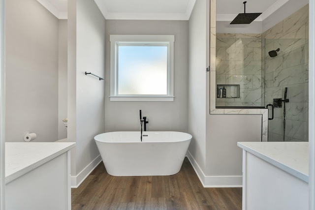 bathroom featuring separate shower and tub, vanity, wood-type flooring, and ornamental molding