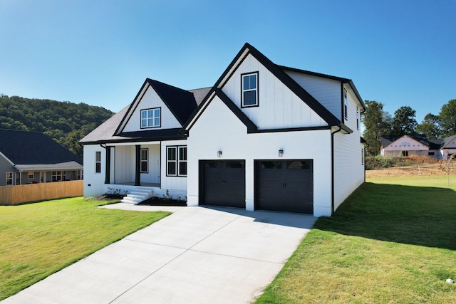 modern inspired farmhouse featuring a front yard and a garage