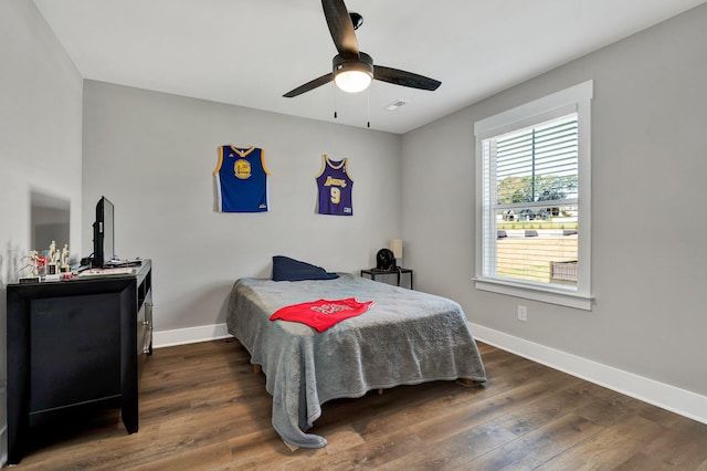 bedroom featuring dark hardwood / wood-style flooring and ceiling fan