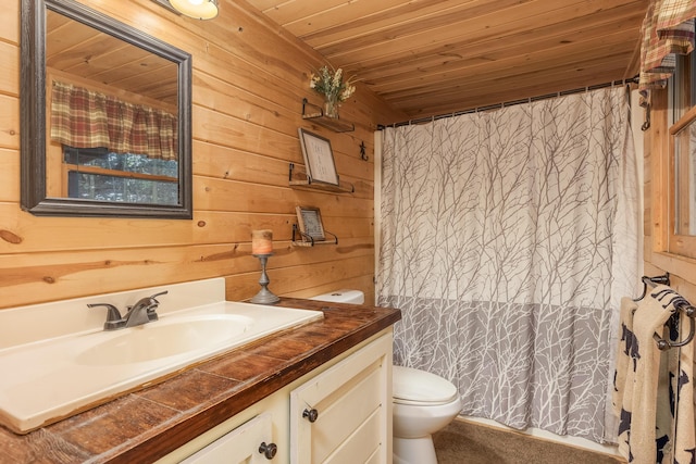 bathroom with vanity, toilet, wood ceiling, and wooden walls