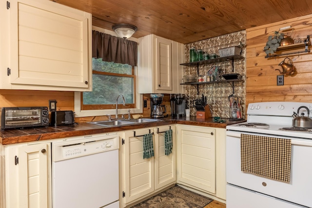 kitchen featuring wood ceiling, white appliances, wooden walls, sink, and cream cabinets