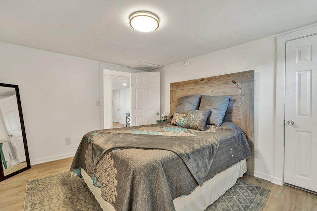 bedroom with hardwood / wood-style floors