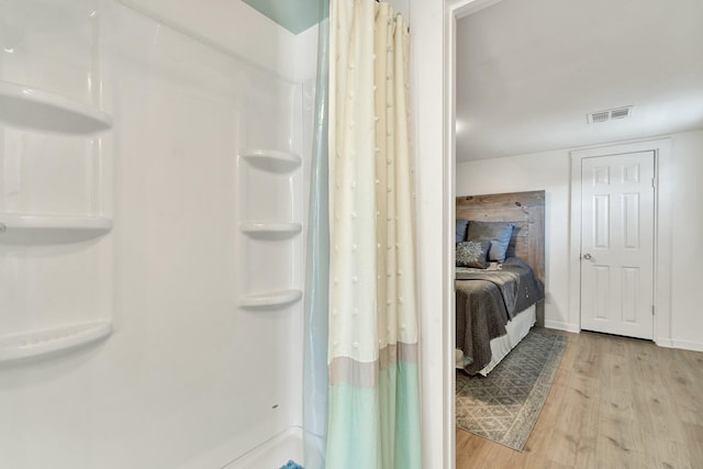 bathroom featuring a shower with curtain and wood-type flooring