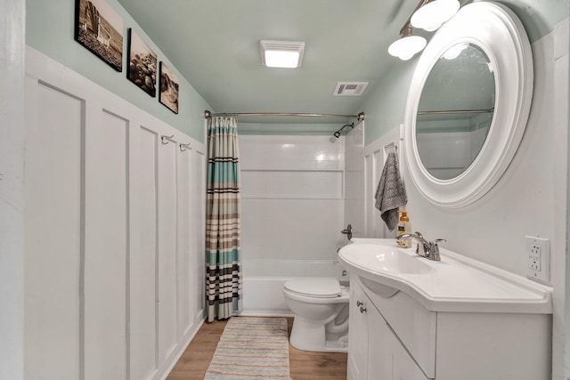 full bathroom featuring toilet, shower / tub combo, hardwood / wood-style flooring, and vanity