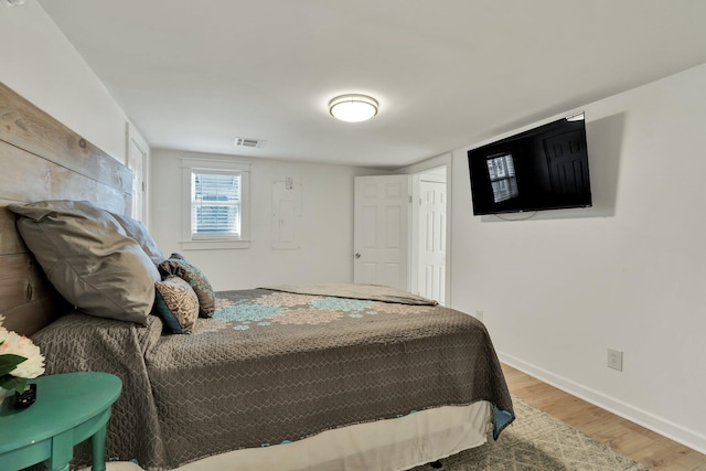 bedroom with wood-type flooring