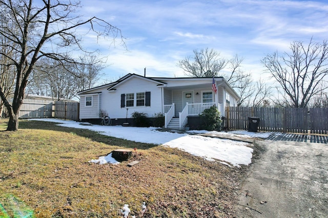 view of front of home with covered porch and a front yard