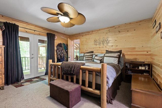 bedroom with wooden walls, french doors, and access to exterior